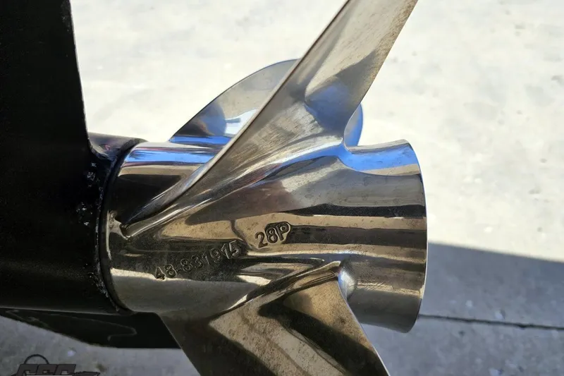 Slide: The Image of Close-up of a polished propeller on a 2001 Powerquest 340 Vyper boat. - 104