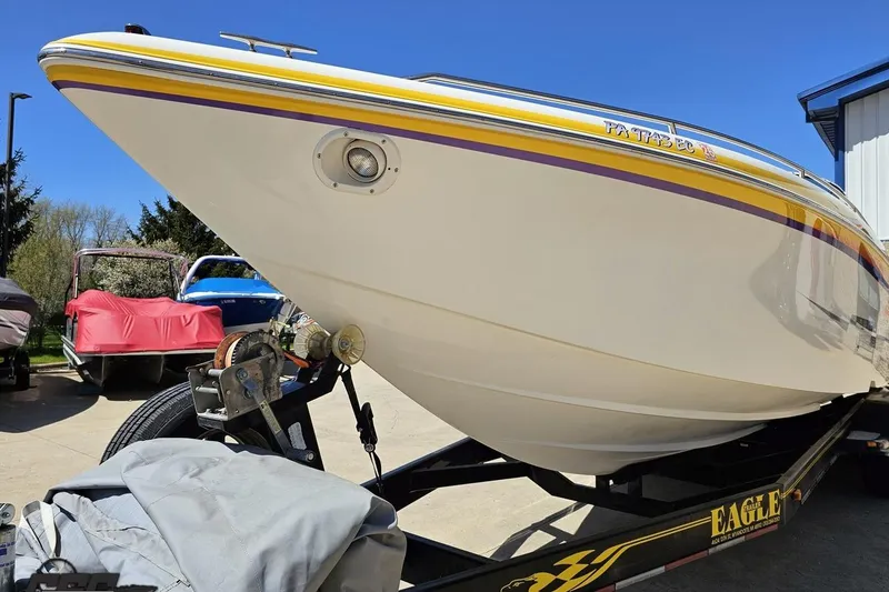 Slide: The Image of 2001 Powerquest 340 Vyper boat on trailer, featuring sleek design and vibrant yellow accents. - 14