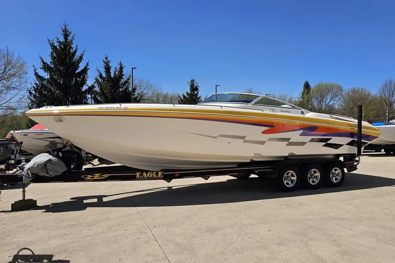 Slide: The Image of 2001 Powerquest 340 Vyper speedboat on trailer, vibrant graphics, parked outdoors. - 16