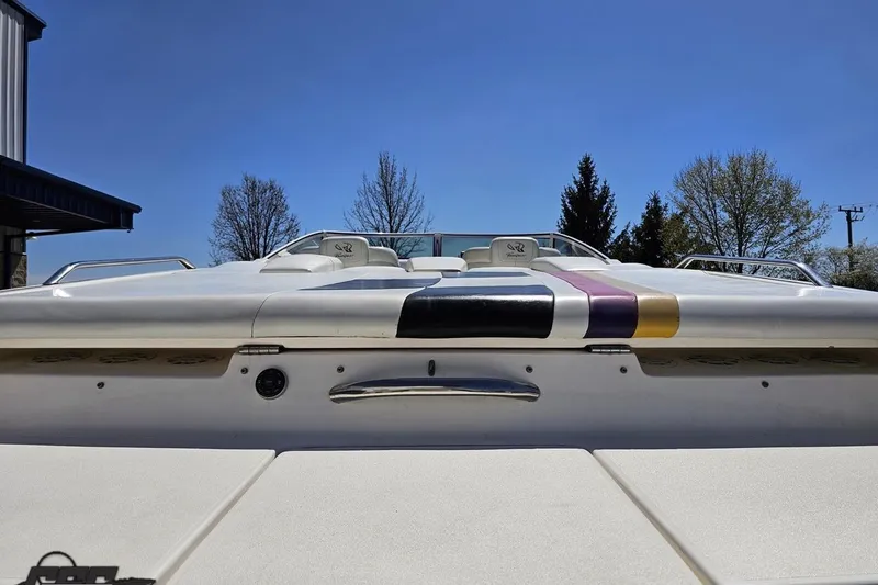 Slide: The Image of 2001 Powerquest 340 Vyper boat, rear view, colorful accents, clear sky background. - 28