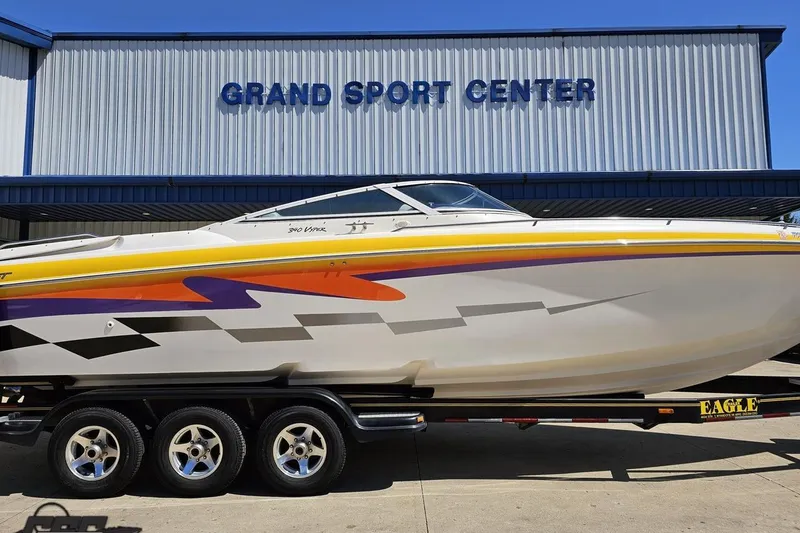 Slide: The Image of 2001 Powerquest 340 Vyper boat with vibrant graphics at Grand Sport Center. - 3