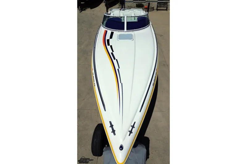 Slide: The Image of 2001 Powerquest 340 Vyper boat with sleek design and colorful stripes on deck. - 35