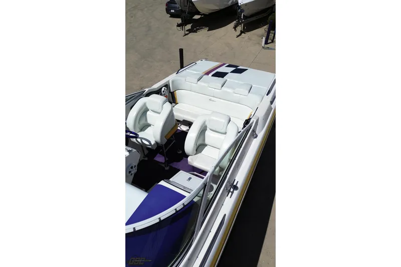 Slide: The Image of 2001 Powerquest 340 Vyper boat interior with white seating and purple accents. - 37