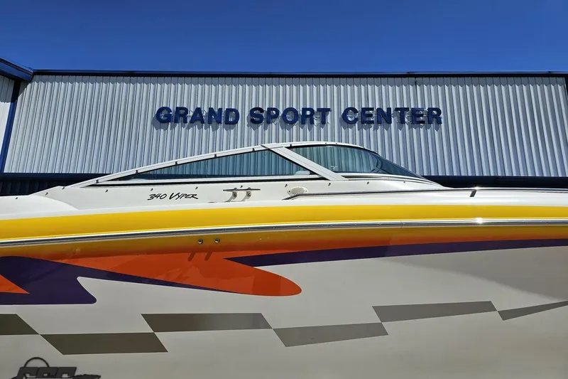 Slide: The Image of 2001 Powerquest 340 Vyper boat at Grand Sport Center, featuring vibrant graphics. - 4
