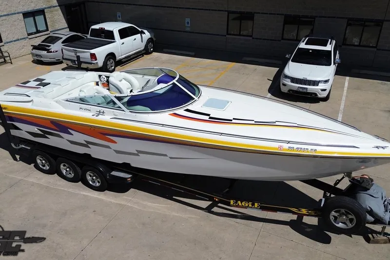 Slide: The Image of 2001 Powerquest 340 Vyper speedboat on trailer, parked in a lot with cars nearby. - 40
