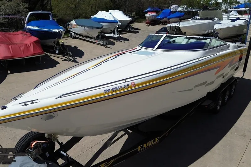 Slide: The Image of 2001 Powerquest 340 Vyper boat on trailer, surrounded by other boats in a marina. - 41