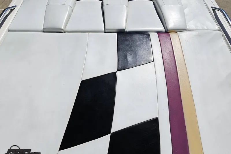 Slide: The Image of 2001 Powerquest 340 Vyper boat upholstery with black, purple, and beige accents. - 47