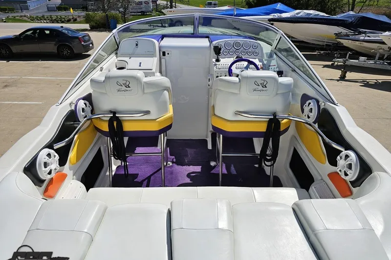 Slide: The Image of 2001 Powerquest 340 Vyper boat interior with white seating, purple accents, and control panel. - 48
