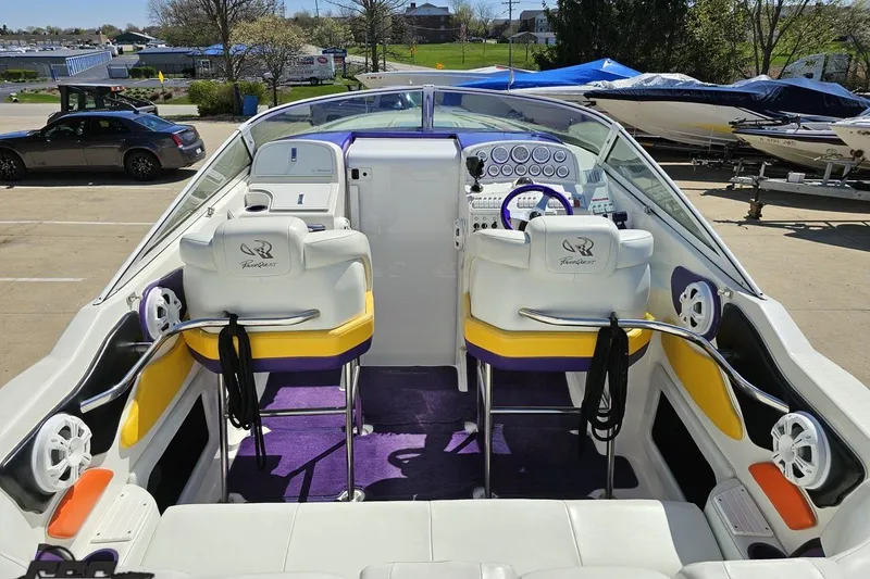 Slide: The Image of Interior of a 2001 Powerquest 340 Vyper boat with vibrant seating and dashboard. - 49