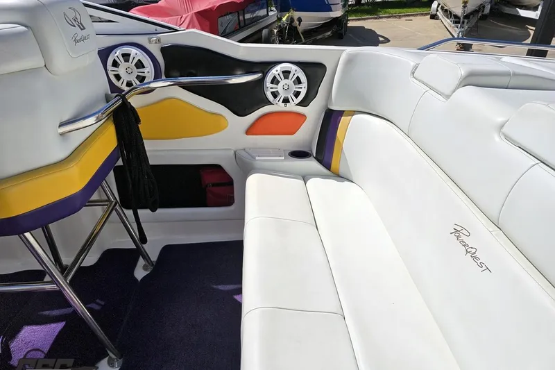 Slide: The Image of Interior of a 2001 Powerquest 340 Vyper boat with white seating and colorful accents. - 52
