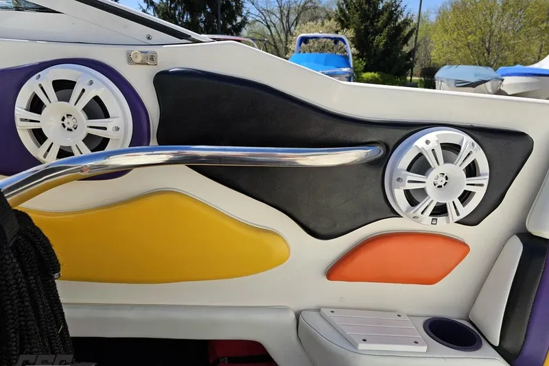 Slide: The Image of Interior of a 2001 Powerquest 340 Vyper boat with colorful panels and speakers. - 53