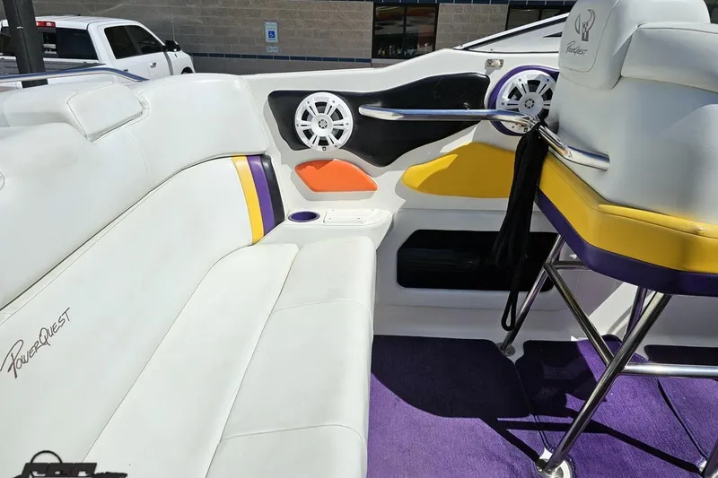Slide: The Image of Interior of a 2001 Powerquest 340 Vyper boat with white and purple seating. - 55