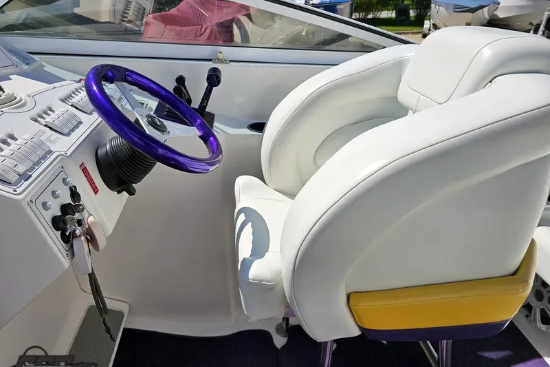 Slide: The Image of Interior of 2001 Powerquest 340 Vyper boat with white seating and purple steering wheel. - 59