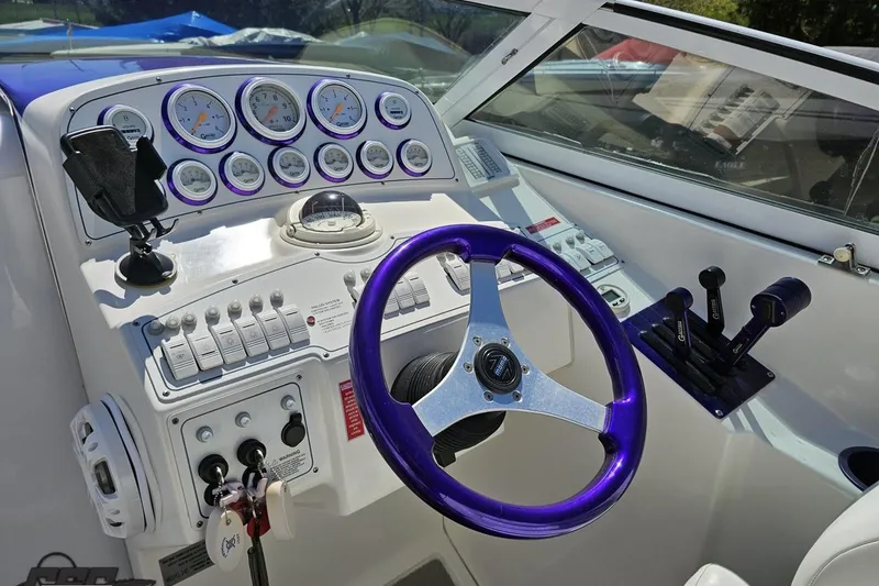 Slide: The Image of Cockpit of 2001 Powerquest 340 Vyper boat with purple steering wheel and gauges. - 60