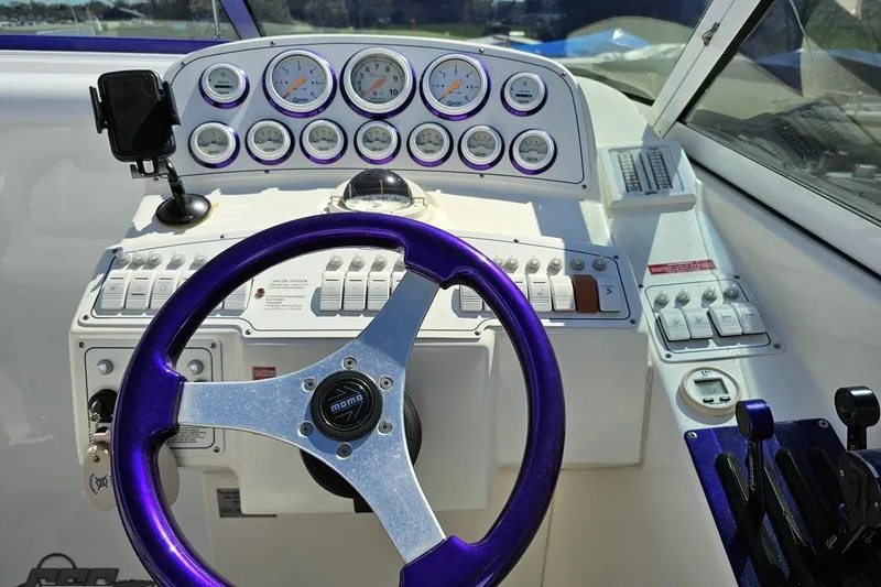 Slide: The Image of Cockpit of 2001 Powerquest 340 Vyper boat with purple steering wheel and gauges. - 62