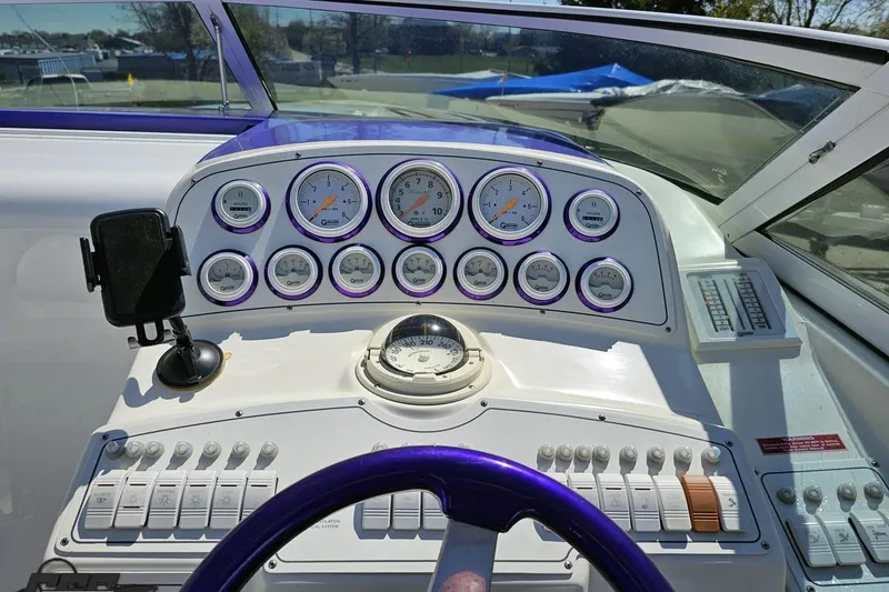 Slide: The Image of Dashboard of a 2001 Powerquest 340 Vyper boat with gauges and controls. - 63