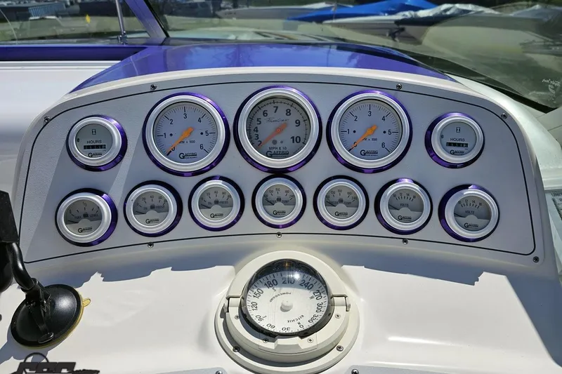 Slide: The Image of Dashboard of a 2001 Powerquest 340 Vyper boat with multiple gauges and compass. - 64