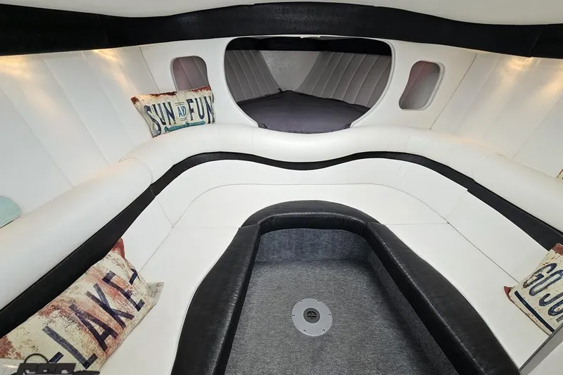 Slide: The Image of Interior of 2001 Powerquest 340 Vyper boat with white seating and decorative pillows. - 69