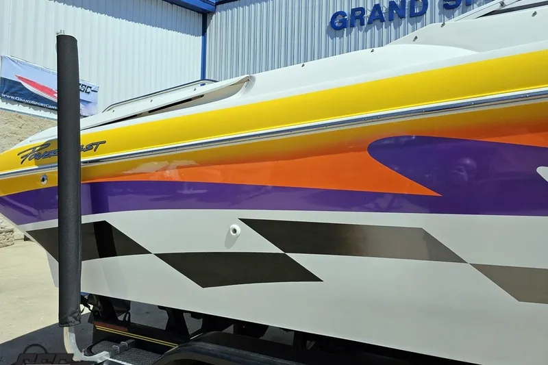 Slide: The Image of 2001 Powerquest 340 Vyper boat with vibrant yellow, orange, and purple graphics. - 7