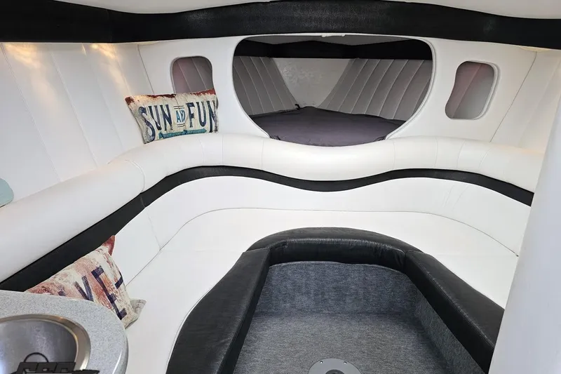 Slide: The Image of Interior of 2001 Powerquest 340 Vyper boat with white seating and decorative pillows. - 70