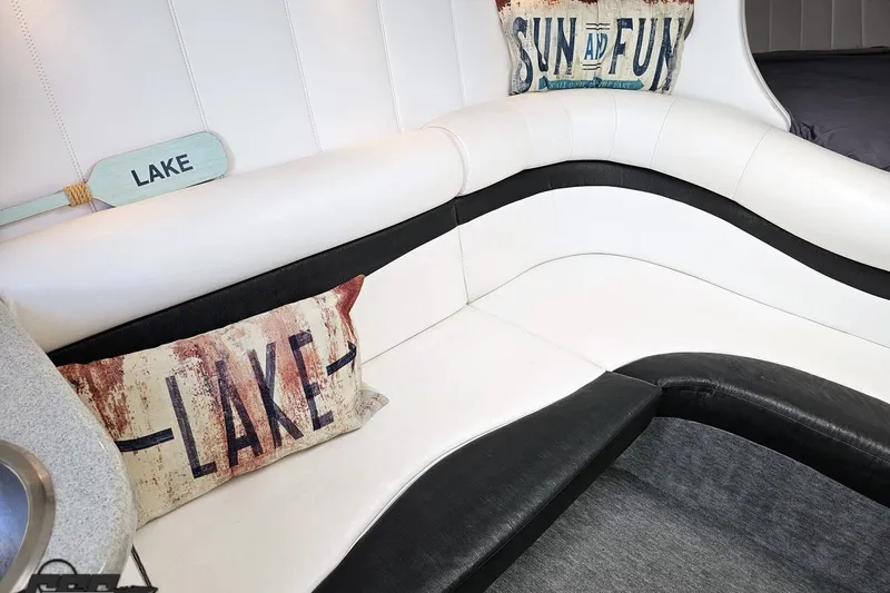 Slide: The Image of Interior of 2001 Powerquest 340 Vyper with lake-themed pillows and white seating. - 74