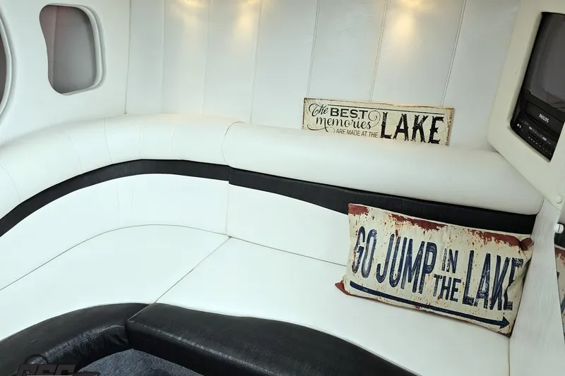 Slide: The Image of Interior of 2001 Powerquest 340 Vyper boat with cozy seating and decorative lake-themed pillows. - 77