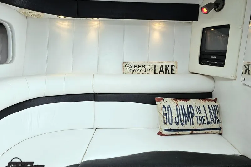 Slide: The Image of Interior of 2001 Powerquest 340 Vyper boat with cozy seating and decorative pillows. - 78