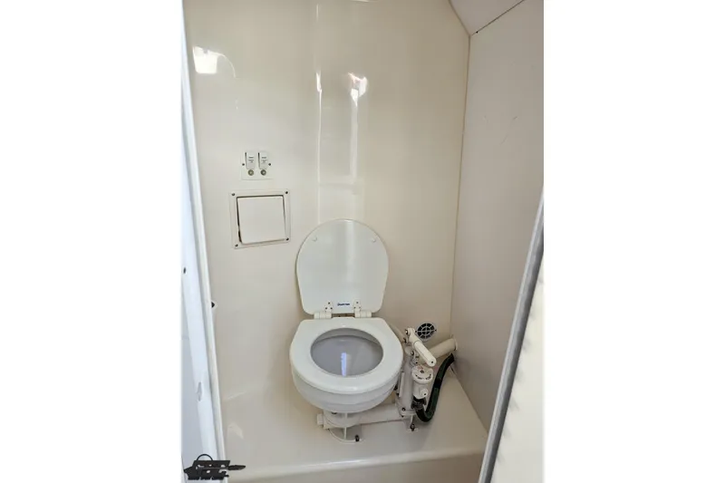 Slide: The Image of 2001 Powerquest 340 Vyper boat bathroom with white marine toilet and compact design. - 80