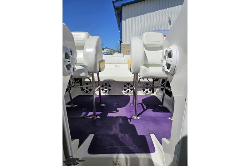 Slide: The Image of Interior of 2001 Powerquest 340 Vyper boat with white seats and purple carpet. - 82
