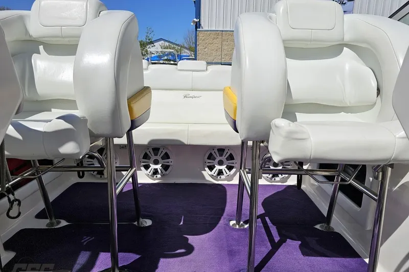 Slide: The Image of Interior of 2001 Powerquest 340 Vyper boat with white seating and purple carpet. - 83