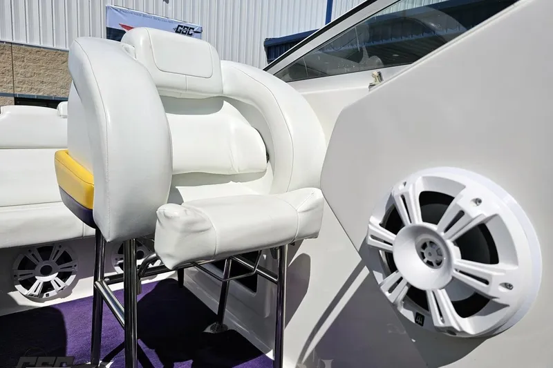 Slide: The Image of Interior of 2001 Powerquest 340 Vyper boat featuring white seating and speaker system. - 84