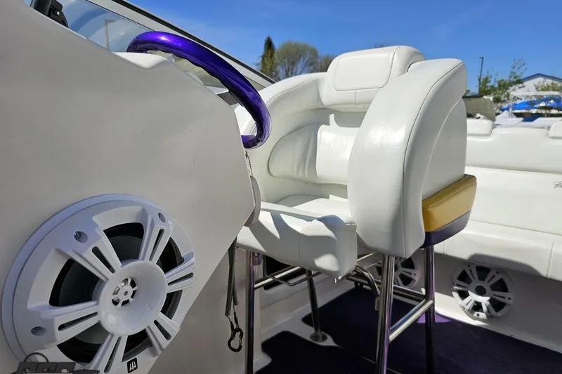 Slide: The Image of Interior of 2001 Powerquest 340 Vyper boat with white seating and purple steering wheel. - 86