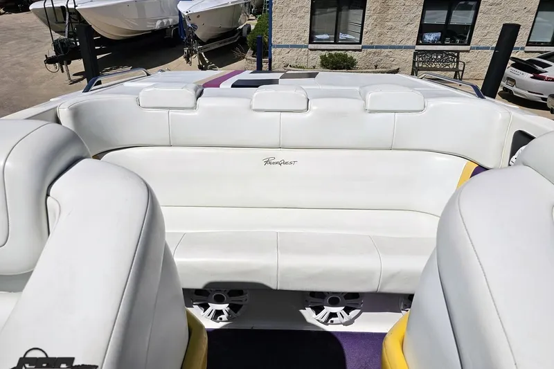 Slide: The Image of 2001 Powerquest 340 Vyper boat interior with white seating and logo. - 89