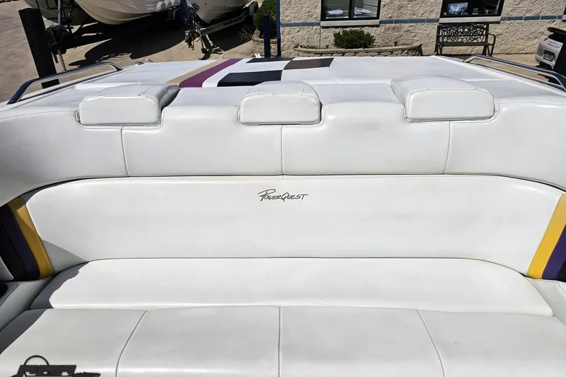 Slide: The Image of 2001 Powerquest 340 Vyper boat interior with white seating and logo. - 90