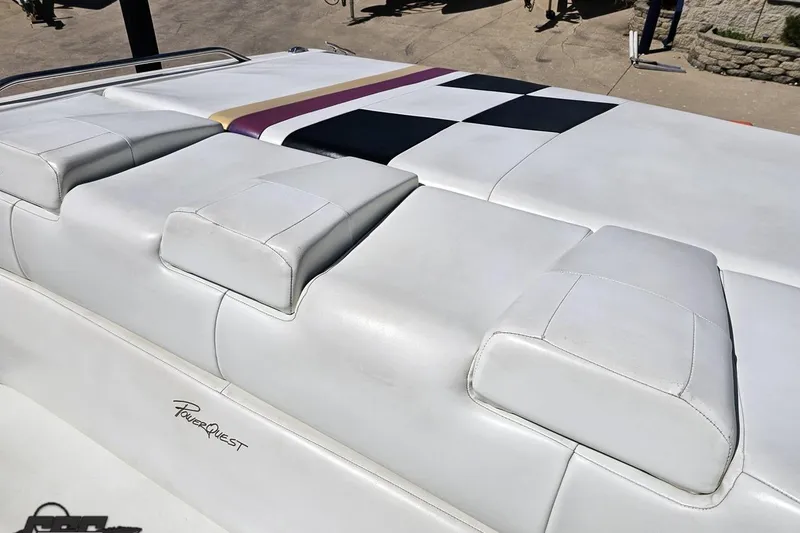 Slide: The Image of 2001 Powerquest 340 Vyper boat with white cushioned seating and checkered design. - 94