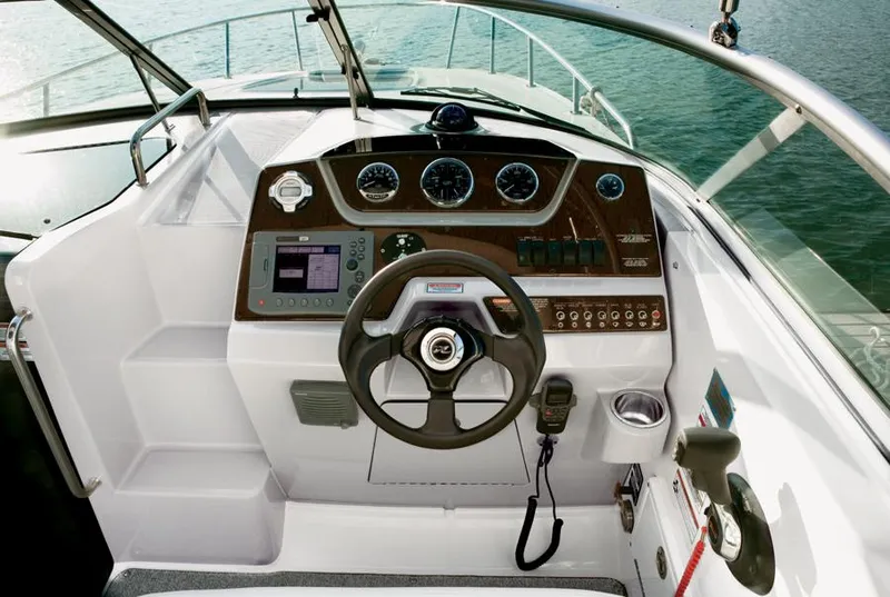 Slide: The Image of Manufacturer Provided Image: 2013 Sea Ray 280 Sundancer boat helm with steering wheel and control panel. - 4