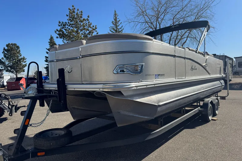 The Image of 2019 Avalon Catalina Rear Fish 25' pontoon boat on trailer, parked outdoors. - 1