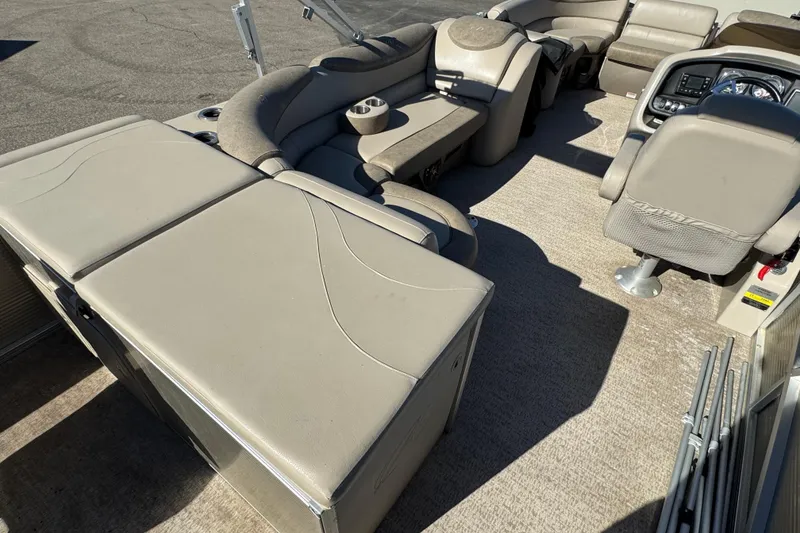 Slide: The Image of 2019 Avalon Catalina Rear Fish 25' boat interior with beige seating and helm. - 12