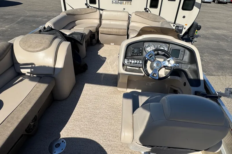 Slide: The Image of 2019 Avalon Catalina Rear Fish 25' boat interior with plush seating and modern dashboard. - 5