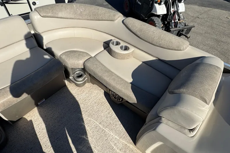 Slide: The Image of 2019 Avalon Catalina Rear Fish boat interior with cushioned seating and cup holders. - 6