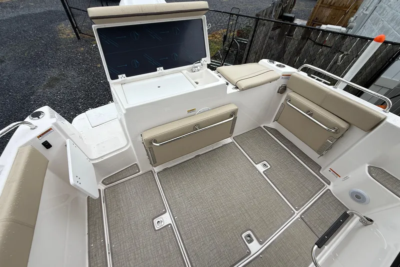 Slide: The Image of 2026 Cutwater C-248 Coupe boat interior with beige seating and storage compartments. - 11