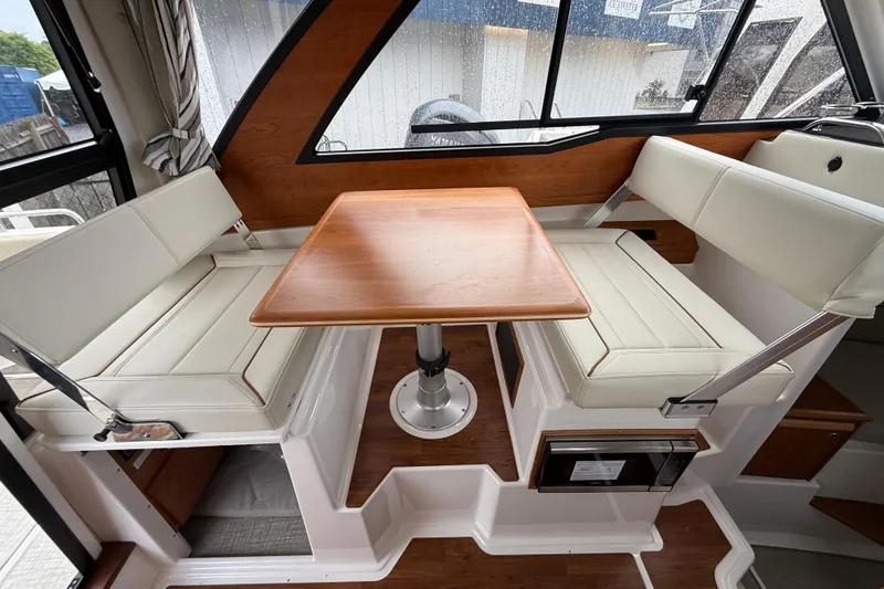 Slide: The Image of Interior of 2026 Cutwater C-248 Coupe featuring a cozy dining area with wooden table. - 12