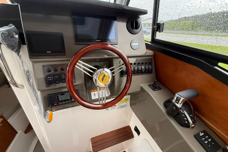 Slide: The Image of 2026 Cutwater C-248 Coupe helm with wooden steering wheel and modern controls. - 14