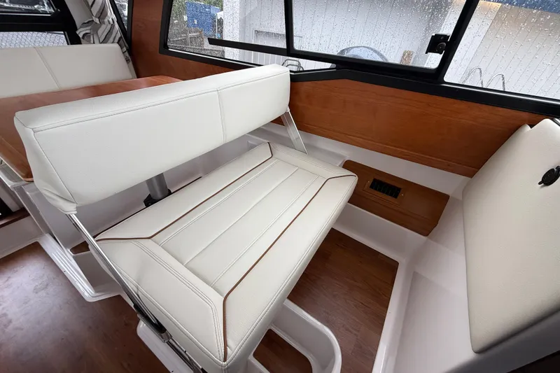 Slide: The Image of Interior of 2026 Cutwater C-248 Coupe with white seating and wood accents. - 16