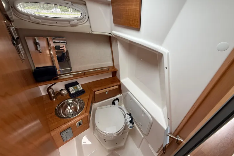 Slide: The Image of 2026 Cutwater C-248 Coupe bathroom with sink, toilet, and mirror. - 17