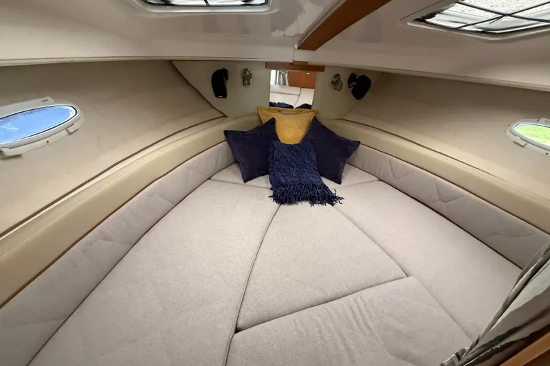 Slide: The Image of Interior cabin of 2026 Cutwater C-248 Coupe with cozy bedding and pillows. - 20