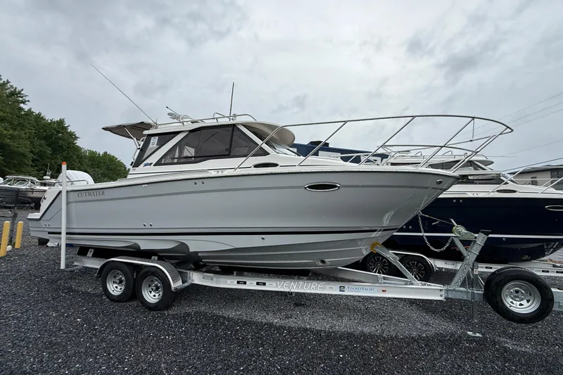 The Image of 2026 Cutwater C-248 Coupe boat on trailer, parked outdoors on gravel. - 6