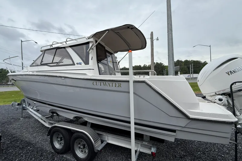 Slide: The Image of 2026 Cutwater C-248 Coupe boat on trailer, side view, overcast sky. - 8