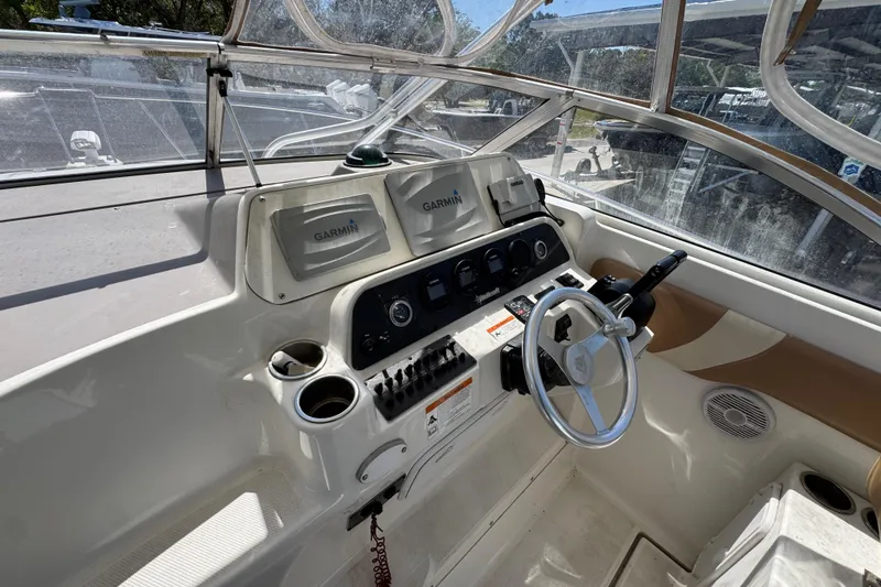 Slide: The Image of 2004 Wellcraft 290 Coastal boat helm with Garmin navigation system and steering wheel. - 19