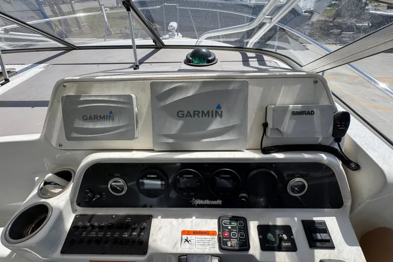 Slide: The Image of Dashboard of a 2004 Wellcraft 290 Coastal boat with Garmin and Simrad electronics. - 21